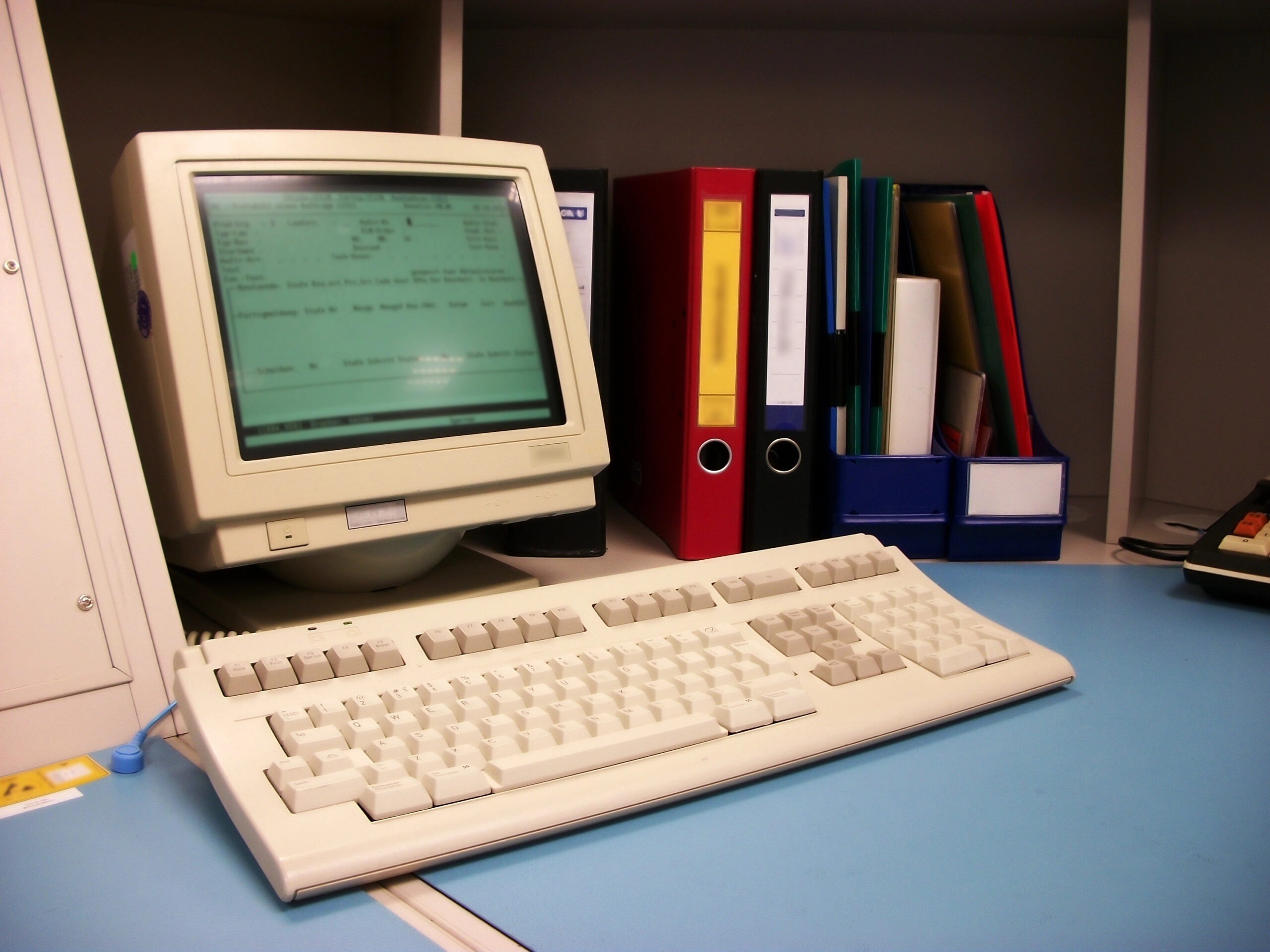 A legacy IT workstation in a manufacturing facility highlighting outdated systems causing hidden costs and compliance risk.